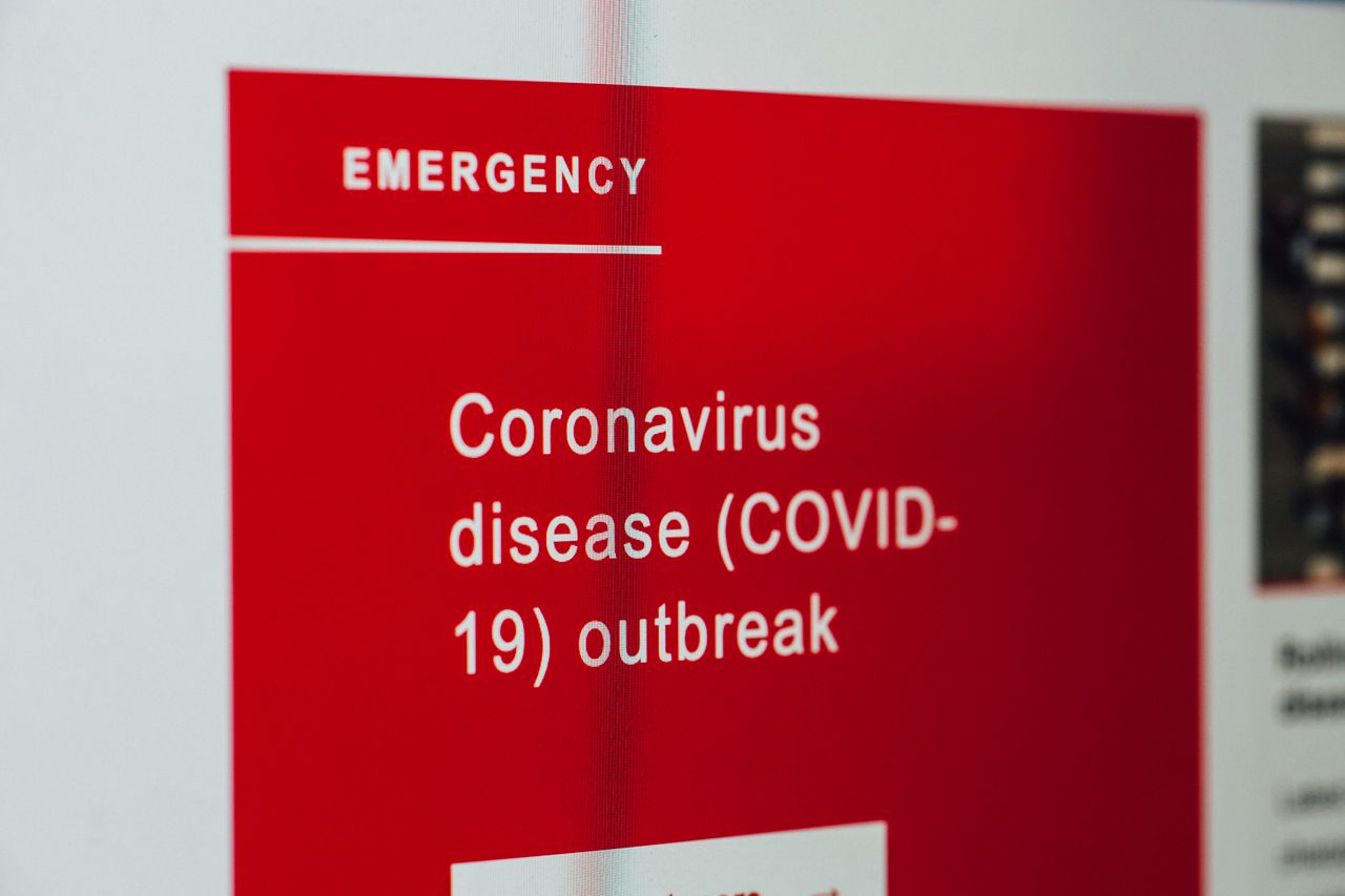 A close-up view of a COVID-19 emergency alert displayed on a digital screen.